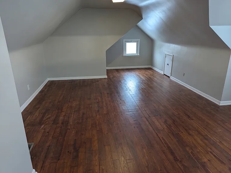 Large top floor with room for a bedroom and a sitting area. New hardwood floors.