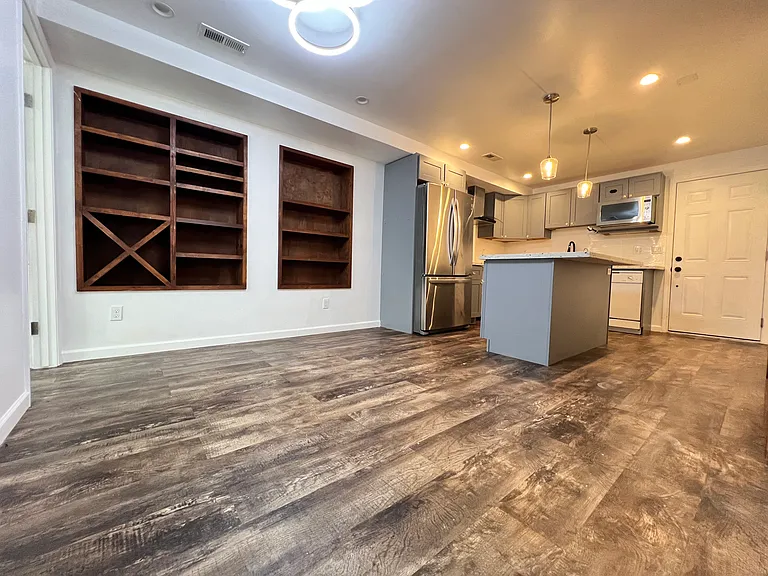 Kitchentte open space with dine-in area. Large enough to fit 6 person dining table. Built in shelves.