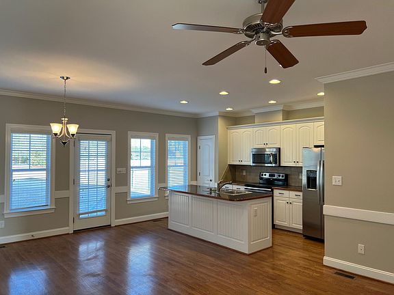 Living Room and Kitchen with stainless steel appliances ! New side by side refrigerator !