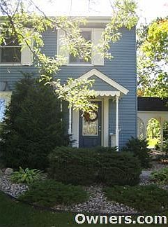 Front of the home is landscaped with rock