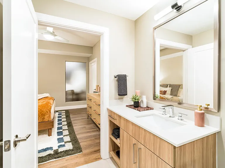 A clean-lined primary bath at Modera McGavock, offering warm finishes, generous storage, and a comfortable retreat just outside Nashville.