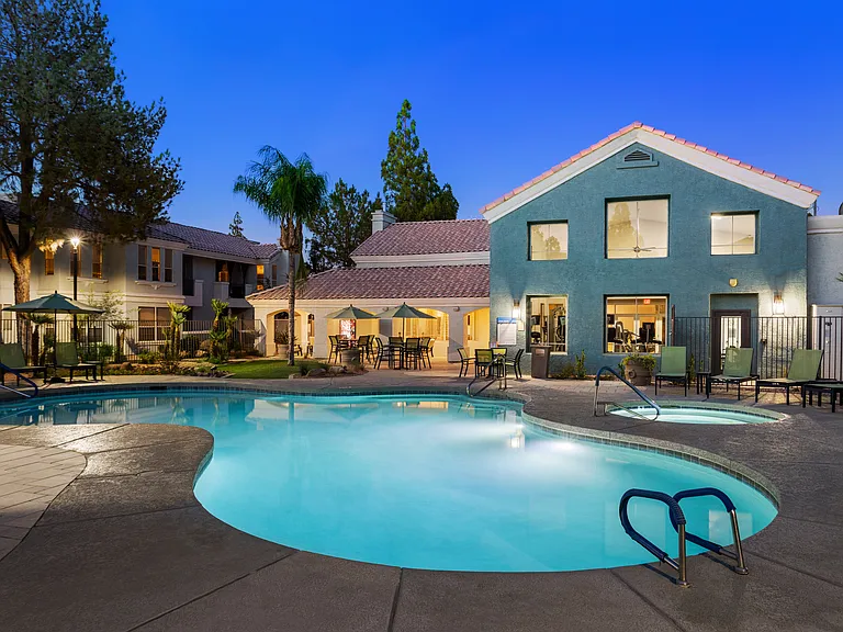 Resort-style swimming pool with cabanas, grills, and a barbeque grill
