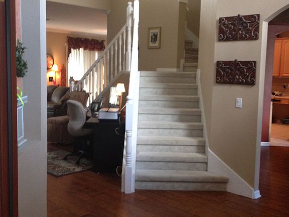 Entry with split stairs and custom wood floors