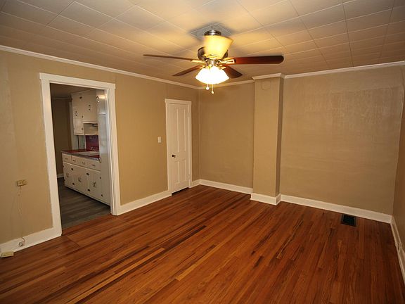 Use this walk through bedroom as an office or dining room. Features large walk in closet with wood shelving for storage and organization.