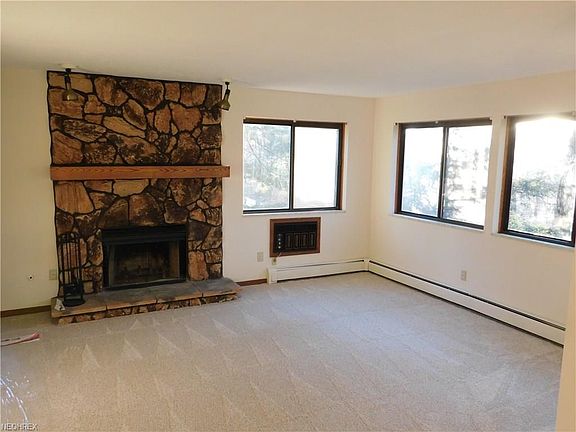 Wood burning fireplace in this well lit living room