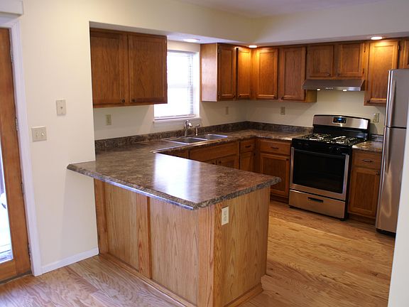 Partially renovated kitchen with new appliances, counter tops and oak floors.