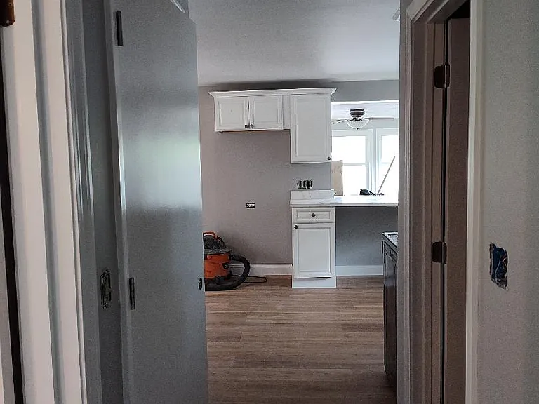 Hallway from the office to bedroom (Left), bath (Right), and kitchen
