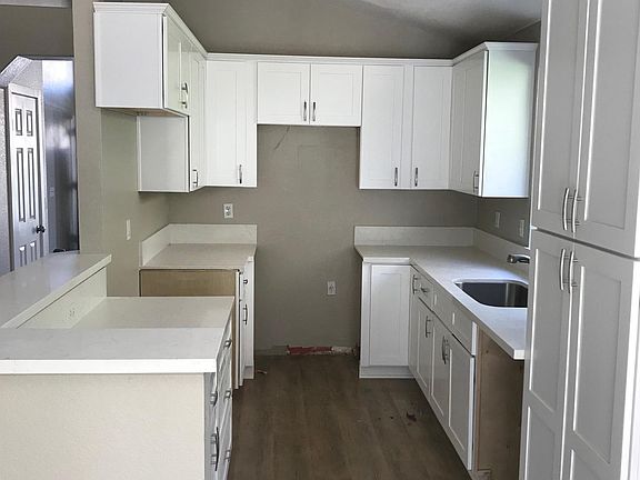 Kitchen with brand new cabinets, sink, faucet and counter to