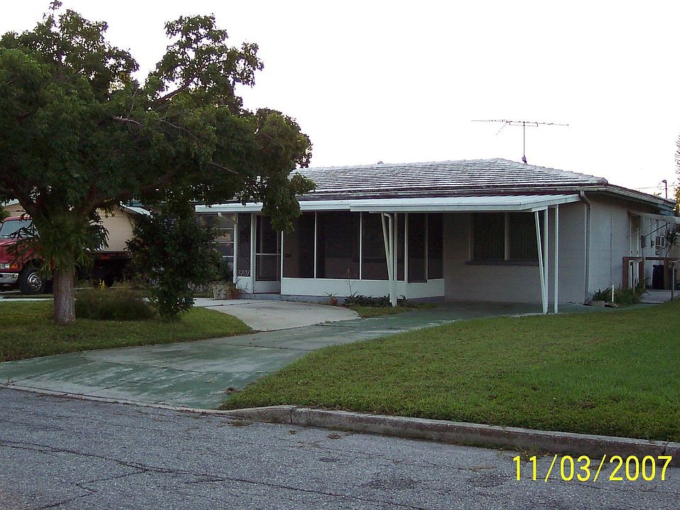 Front with circular drive and screened in porch