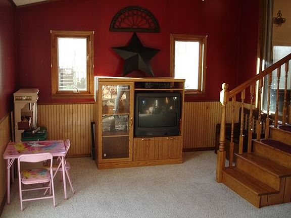 All season sunroom opens to paver patio with Koi pond