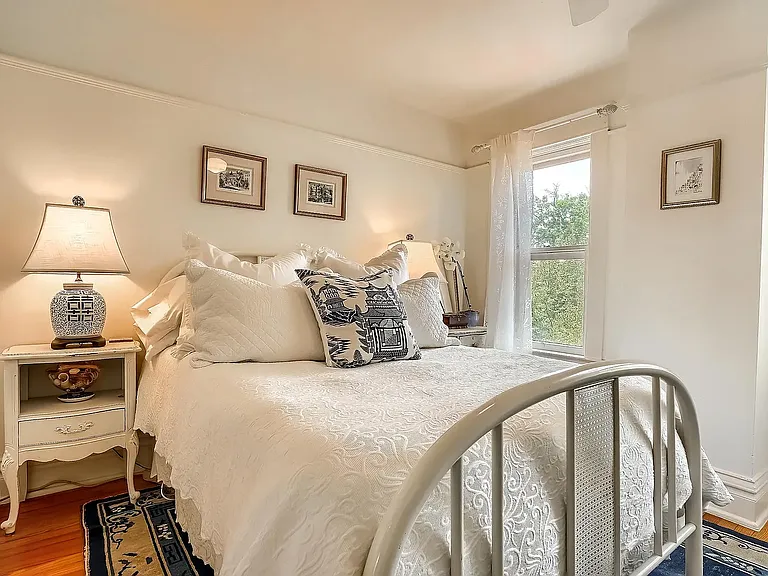 Third bedroom with hardwood floor with backyard view