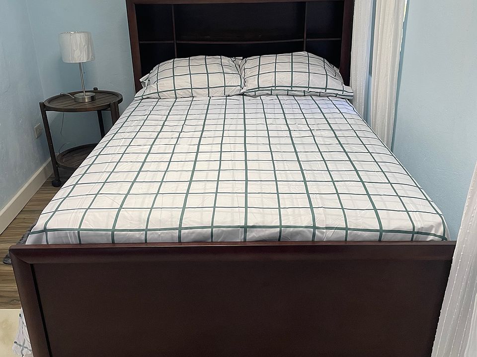 Cozy bedroom. Full-sized bed with pull-out drawers for storage.