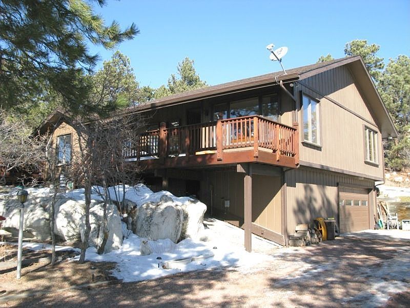 Front of Home - Nestled in the trees on .67 acres. 