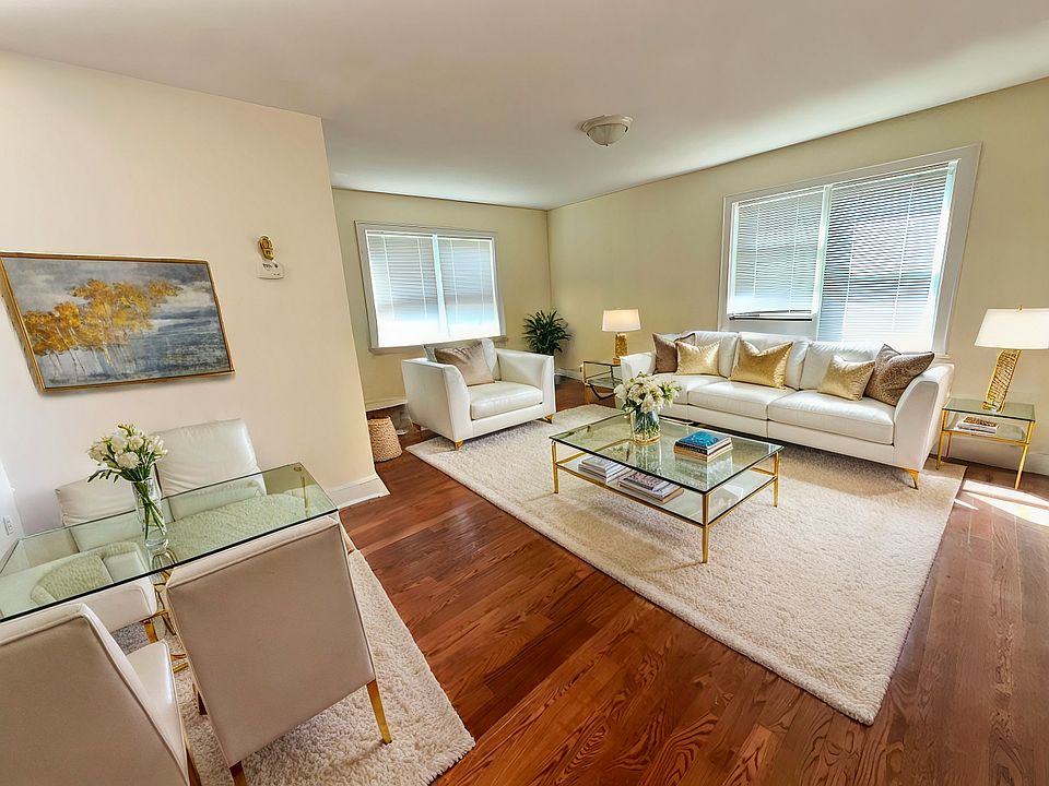 Living Room - Virtually Staged - Living room with dark hardwood / wood-style flooring and a healthy amount of sunlight.