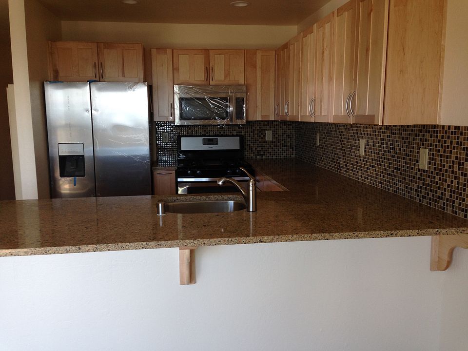 Remodeled kitchen with stainless appliances and gas stove.