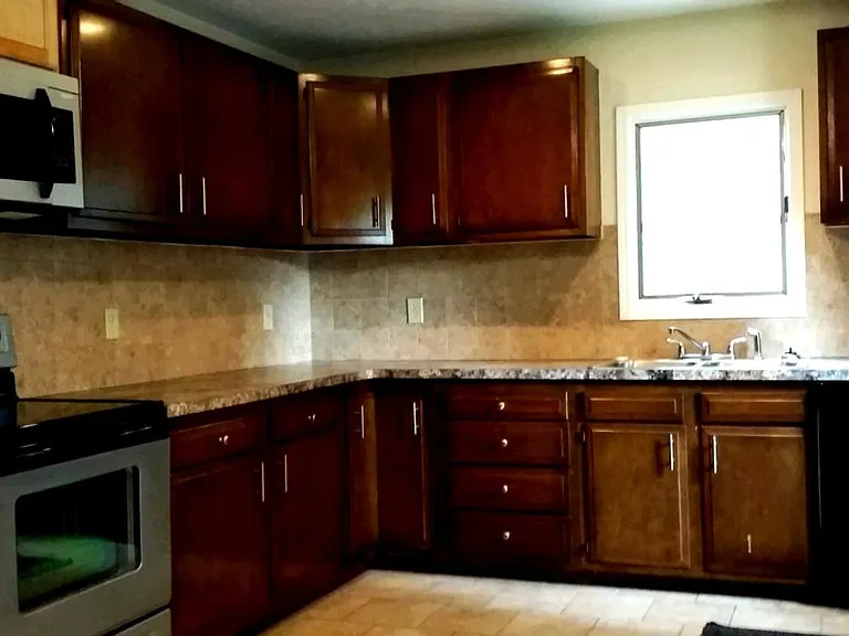 Roomy kitchen, lots of counter and storage space. Refrigerator, stove, microwave and utensils included.
