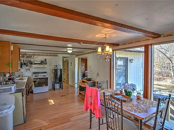The kitchen and dining room hold a full complement of appliances.