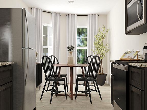 Recessed LED lighting and a beautiful bay window keep things bright in the breakfast nook.