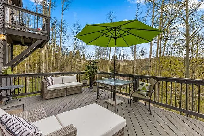 Back deck off of main level, with hot tub and outdoor furniture
