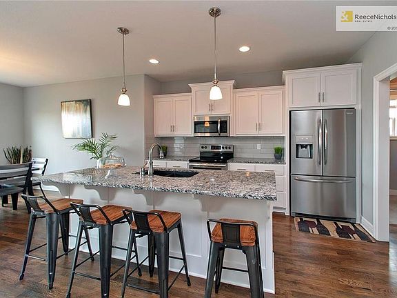 Open Kitchen w/Large Island, Enameled Cabinets, Hardwood Floors, SS Appliances, Walk-in Pantry & Breakfast Room!