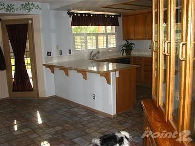 Beautiful Kitchen plus wooden window shutters and tile floors through out