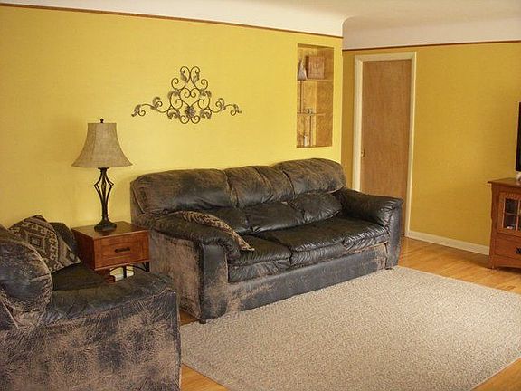 Open Living Room w/hardwood floors and large picture window.