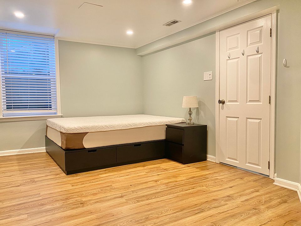 Queen sized bed with under-bed storage, nightstand, lamp