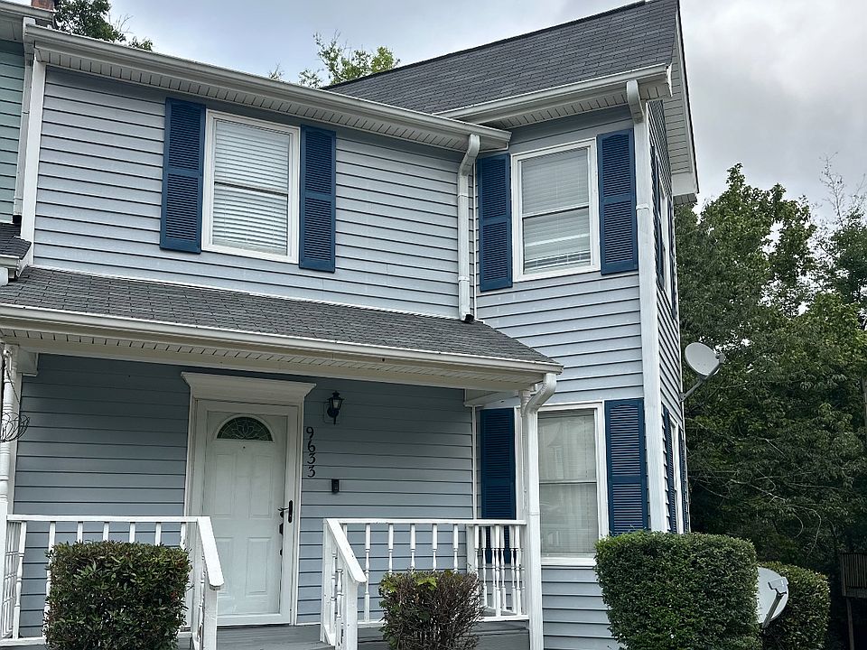 End home of three with small fencing area in back with deck