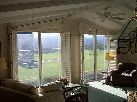 Plantation shutters open to let in the view.