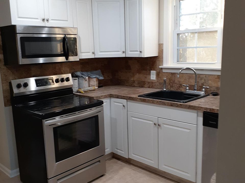 Kitchen fully furnished with stainless steel range, refrigerator, dishwasher, an microwave