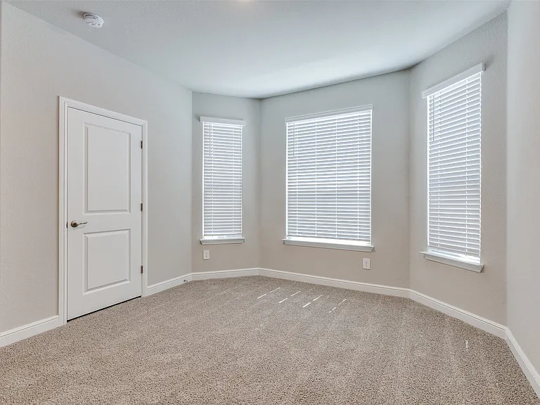 Unfurnished room featuring light carpet