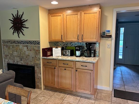 Coffee bar with coffee maker (regular and K-cup), electric tea kettle, blender, and toaster.