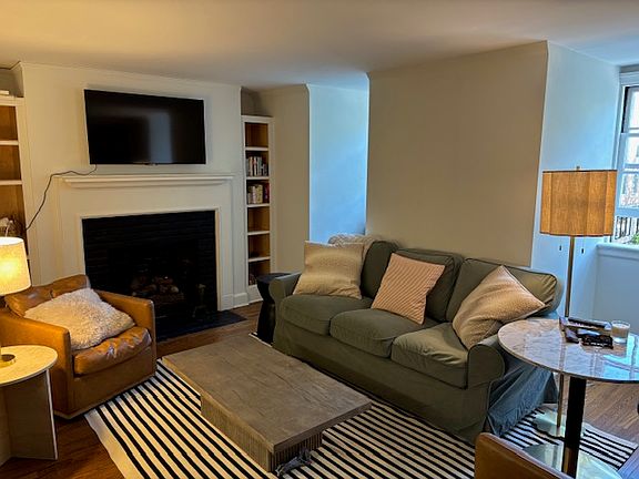 Living room with two windows and window unit.