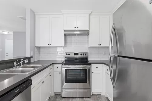 Upstairs with balcony kitchen - Amarville Apartments and Townhomes