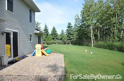 Patio with complete fenced in backyard.
