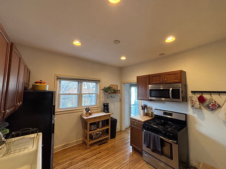 Kitchen facing doorway to pantry and backyard