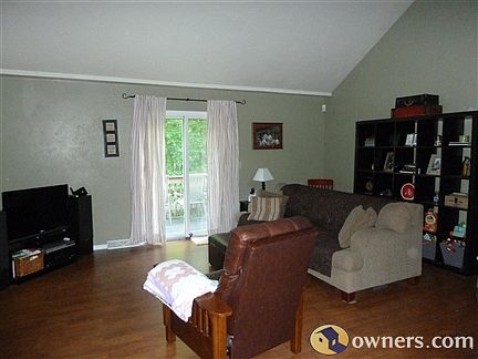 Living room. Very open with vaulted ceiling. Door to deck. 18x14