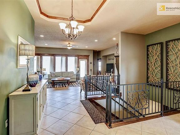 Large Open Front Entrance with Double Wide Staircase to Lower Level