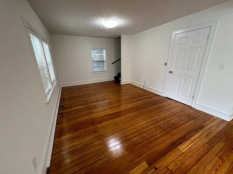 Living room area. Large coat/storage closet. Stairs lead to second story