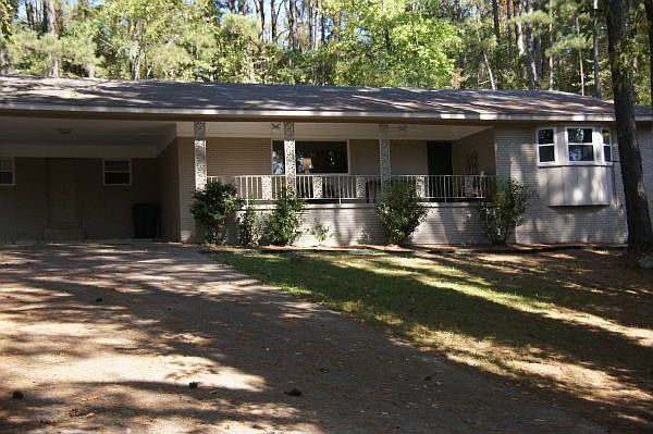 Home sits on 1/2 acre lot with covered front porch