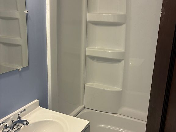 Complete bathroom renovation with new tub and fixtures, new vanity, paint, plumbing, and new flooring.