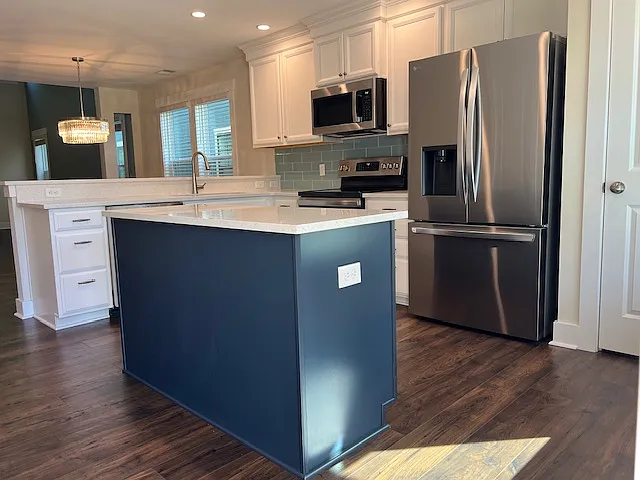 Kitchen with stainless steel appliances and quartz counters