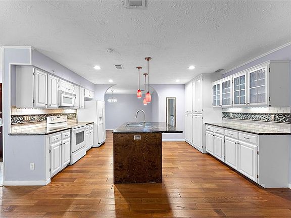 Remodeled Kitchen with granite counter tops and island with double sinks.