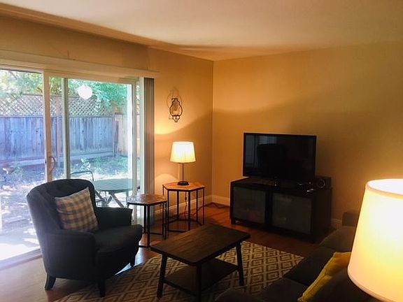 Living room opens to a back yard space