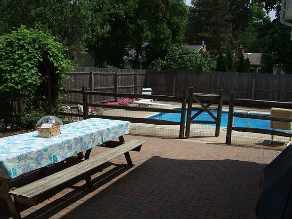 Large picnic table on brick patio.