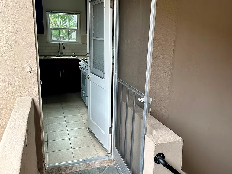 Back entryway into the kitchen, beautiful exterior tiling, from the back staircase