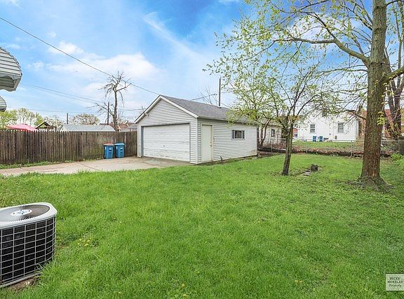 Two car garage with room for lawn mower and snow blower and other storage needs.