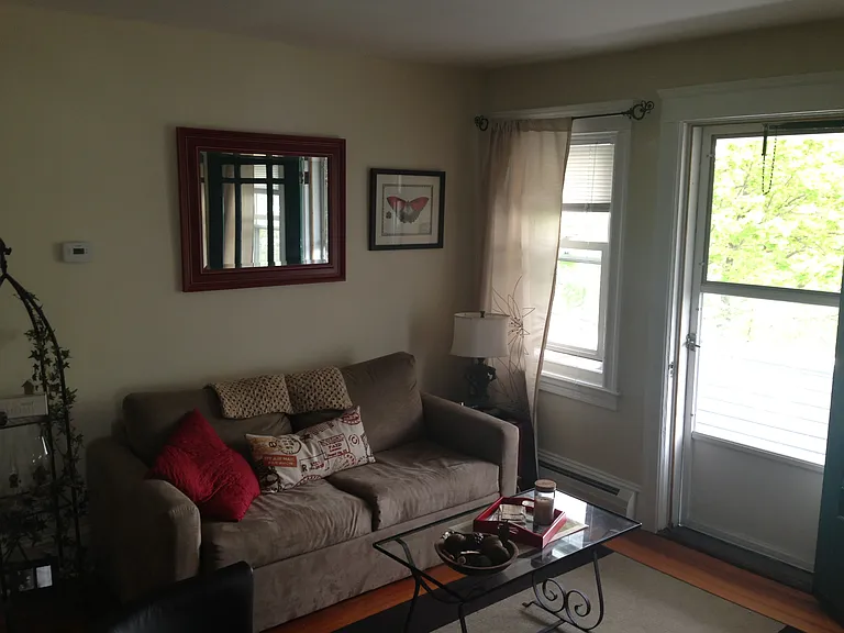 view to living room corner and access to balcony.