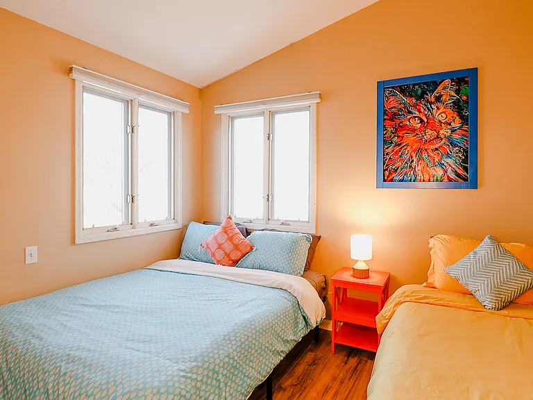 A cozy bedroom designed with soft lighting, plush bedding, and soothing colors, creating a tranquil sanctuary for rest and relaxation.
