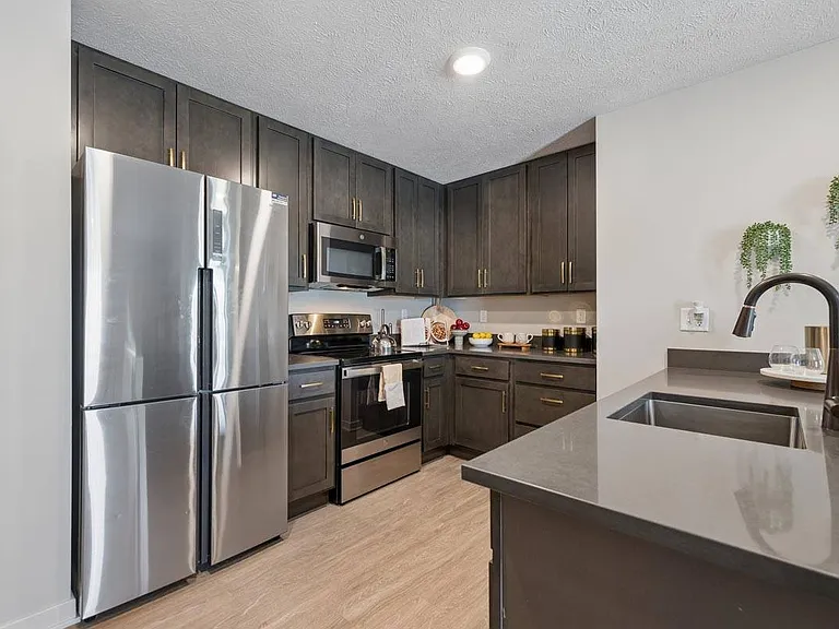 Sleek finishes, modern appliances, and generous workspace create a kitchen designed for both effortless meals and everyday moments.